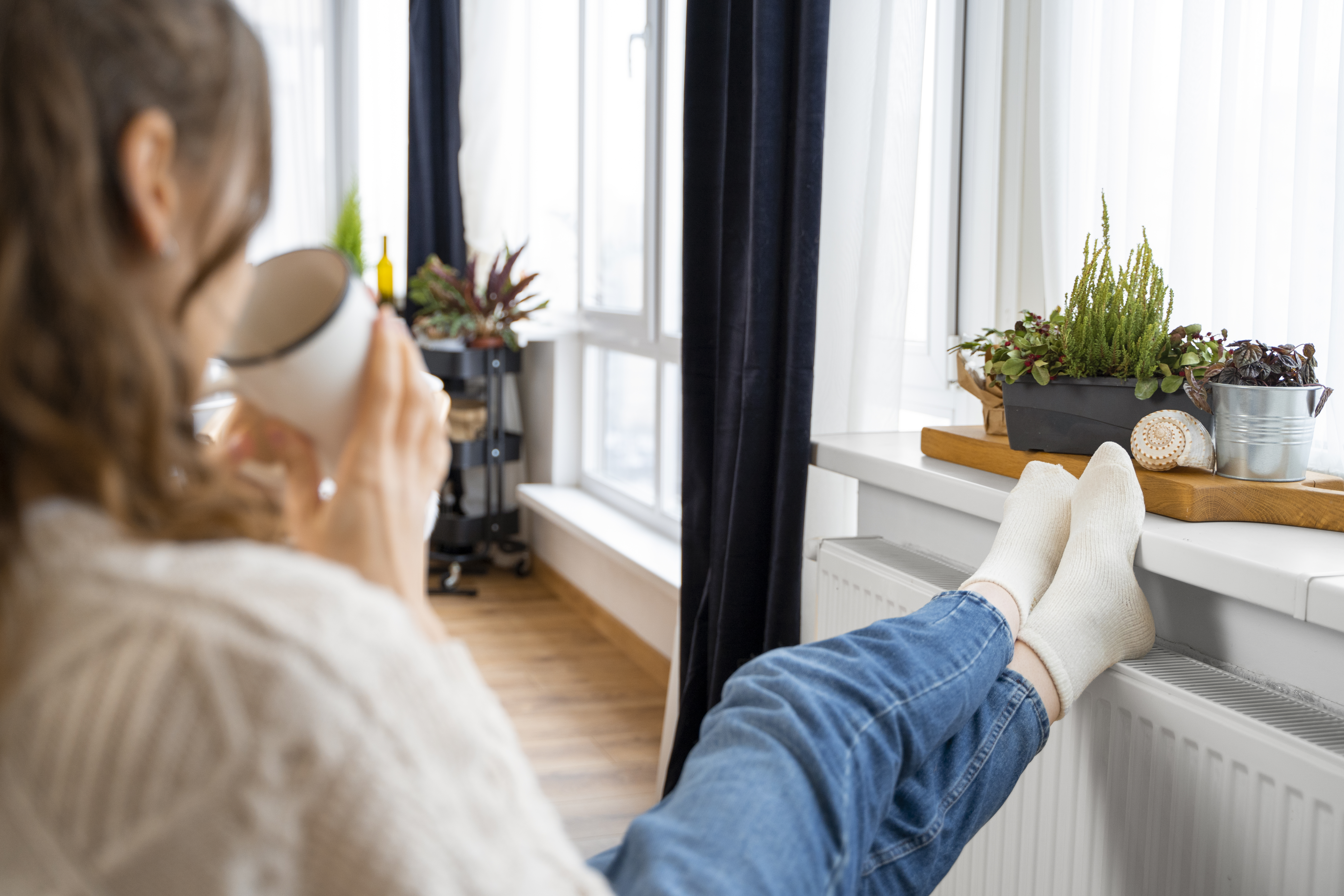 Close-up of Woman Sitting Near Heater
